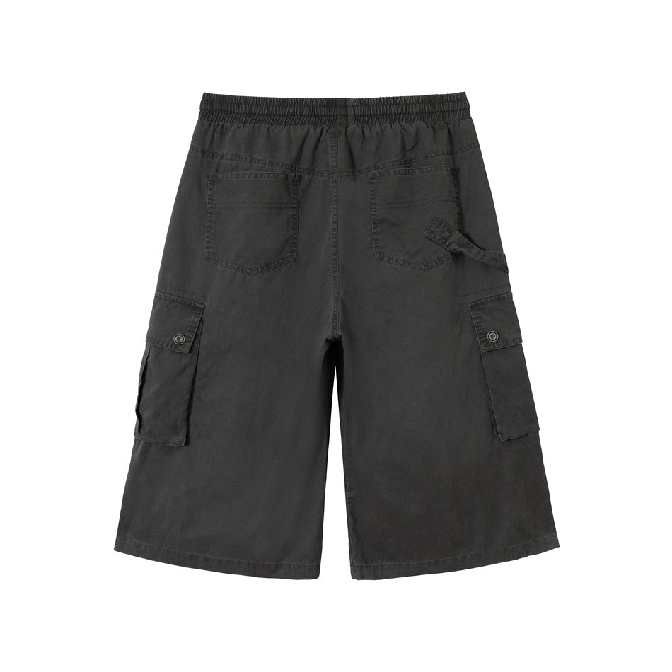 Back view of charcoal wide-leg cargo shorts with two rear pockets, side cargo pockets, and an elastic waistband.