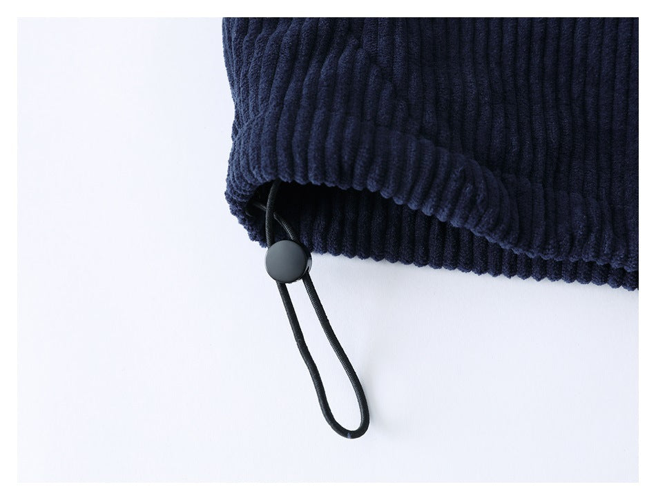 Close-up of a dark navy ribbed hem with an adjustable black drawcord and toggle.