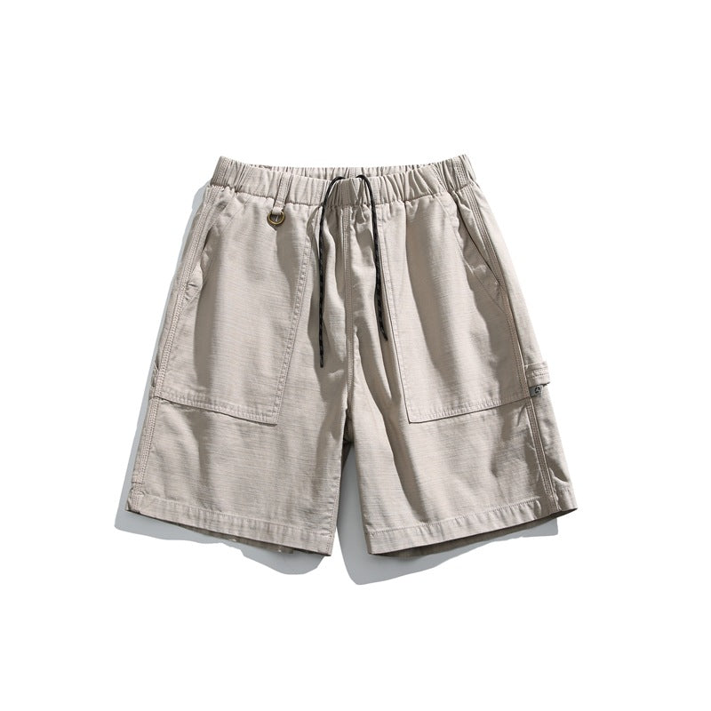 Sand beige men's drawstring shorts with large front patch pockets, front view on white background