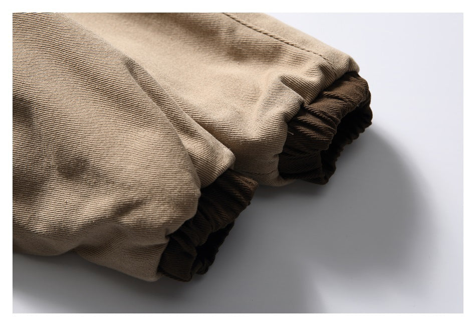 Close-up of a tan jacket sleeve gathered into a dark brown elastic cuff.