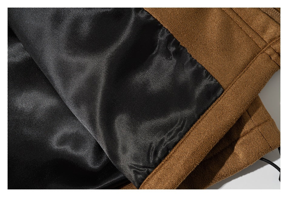 Close-up of the coat opened to show its black lining and camel-brown outer fabric.