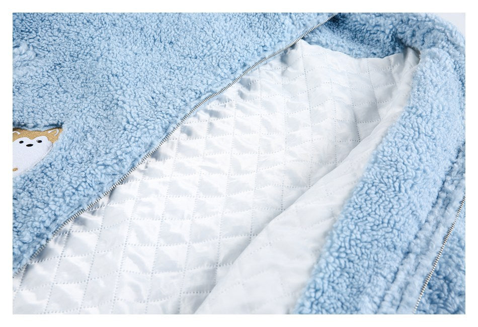 Open light blue plush jacket showing its white diamond-quilted lining and zipper.