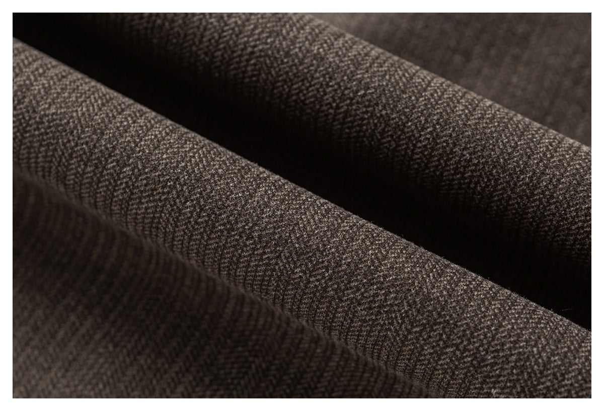 Macro view of dark brown fabric with a small woven check texture.