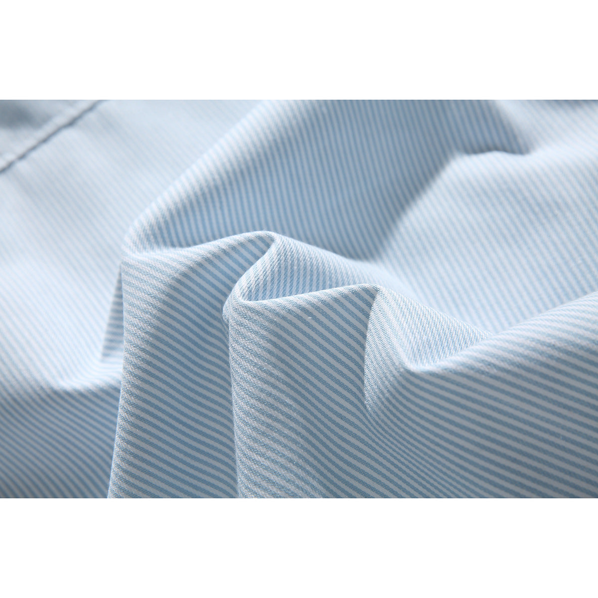 Close-up of pale blue and white striped shirt fabric draped into soft folds.