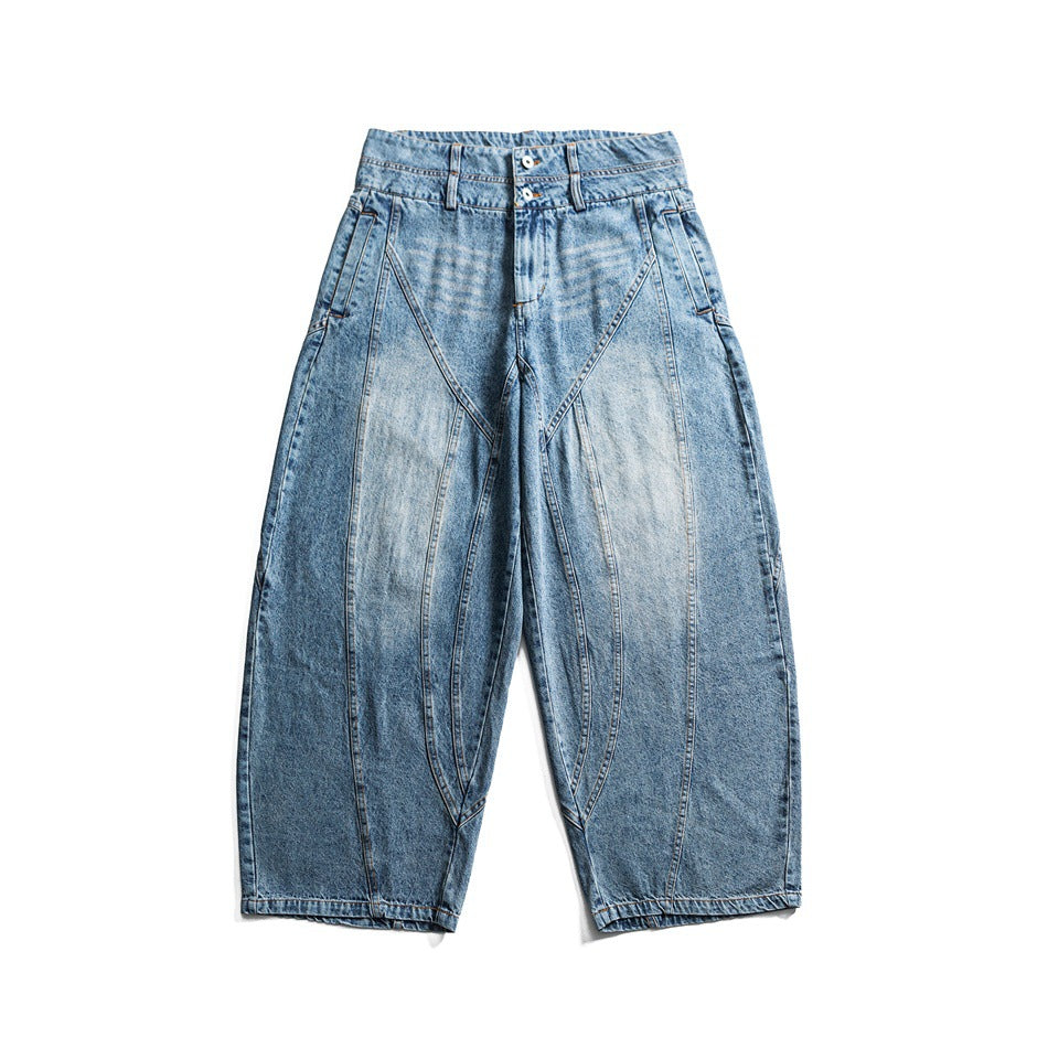 Light blue washed wide-leg jeans with faded thighs, double-button waistband and curved seams, flat lay front view