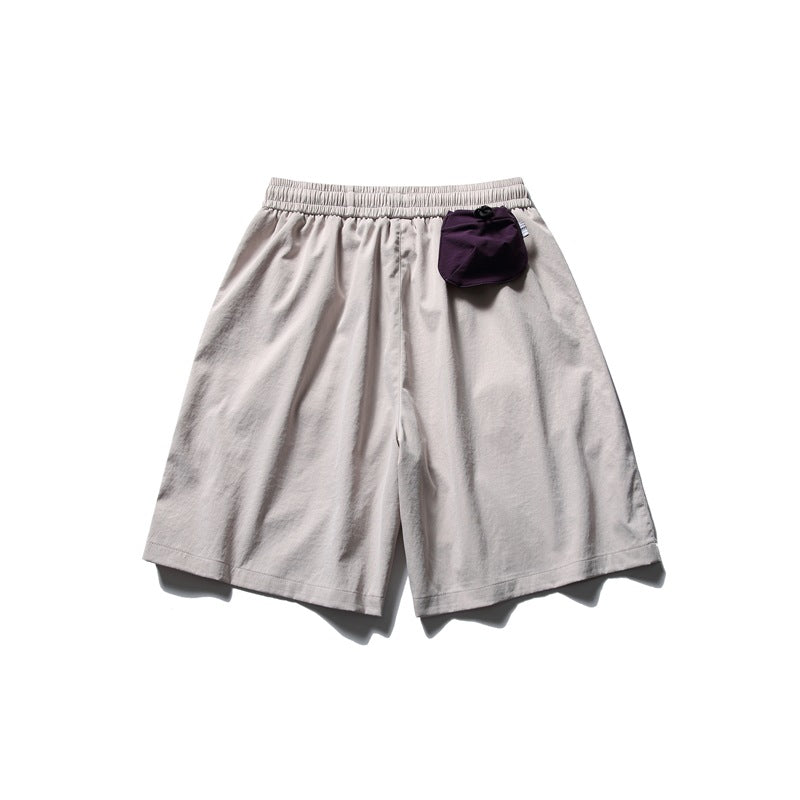 Light gray shorts with an elastic waistband and a small dark purple pouch attached near the waist.