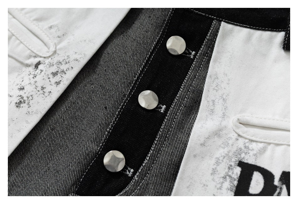 Close-up of the jeans' black button fly between gray denim and white graphic panels.