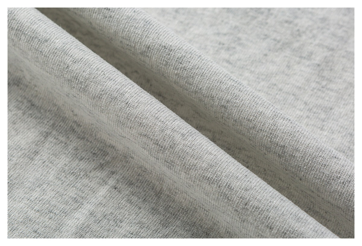 Close-up of softly folded heather-gray knit fabric.