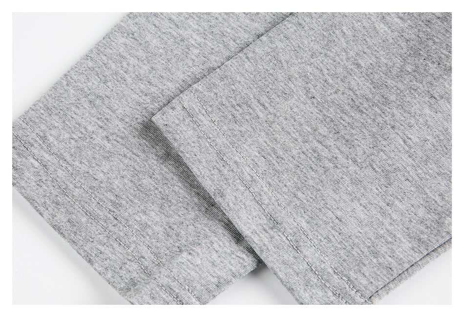 Close-up of a heather gray shirt sleeve cuff with double-row stitching.