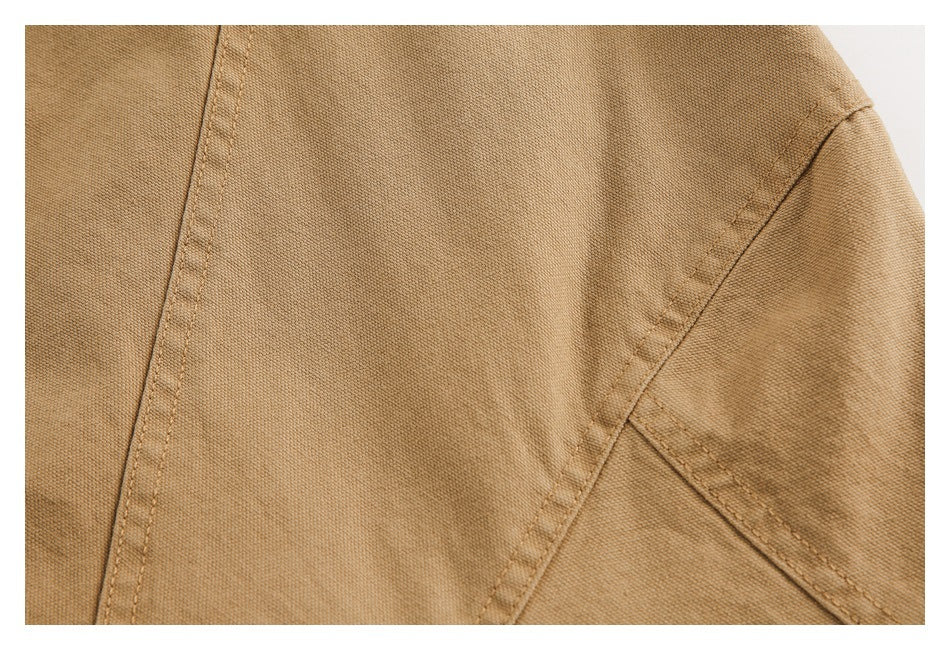 Close-up of camel-brown garment panel construction with intersecting stitched seams.