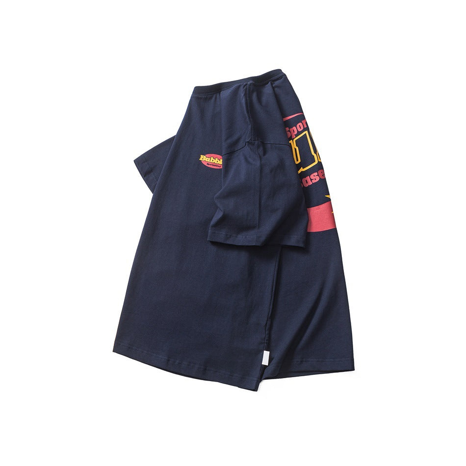 Folded navy short-sleeve T-shirt showing a small chest logo and part of a larger colorful graphic.