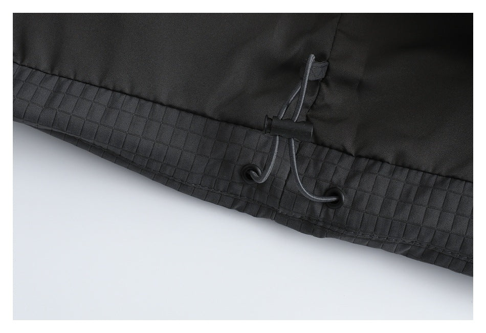 Close-up of the vest hem's adjustable drawcord, eyelets, and quilted trim.