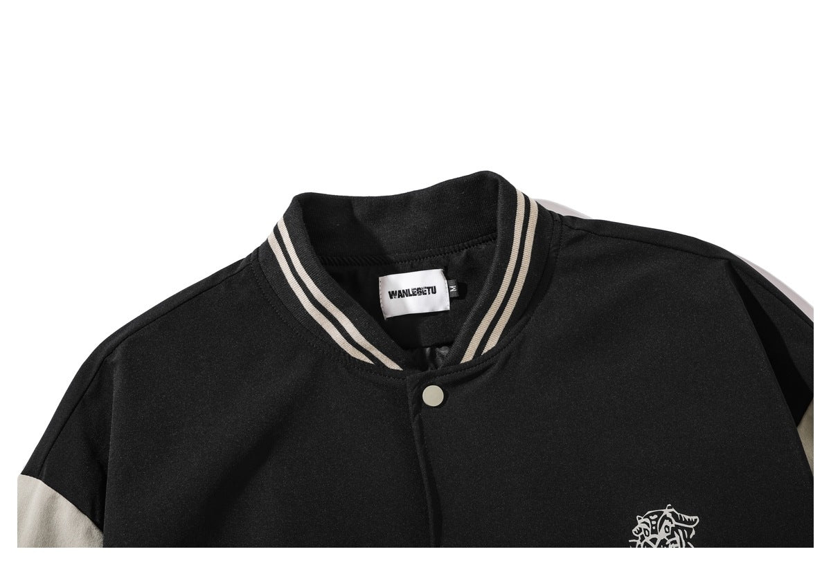 Close-up of the black jacket's striped ribbed collar, top snap, neck label and partial chest graphic.