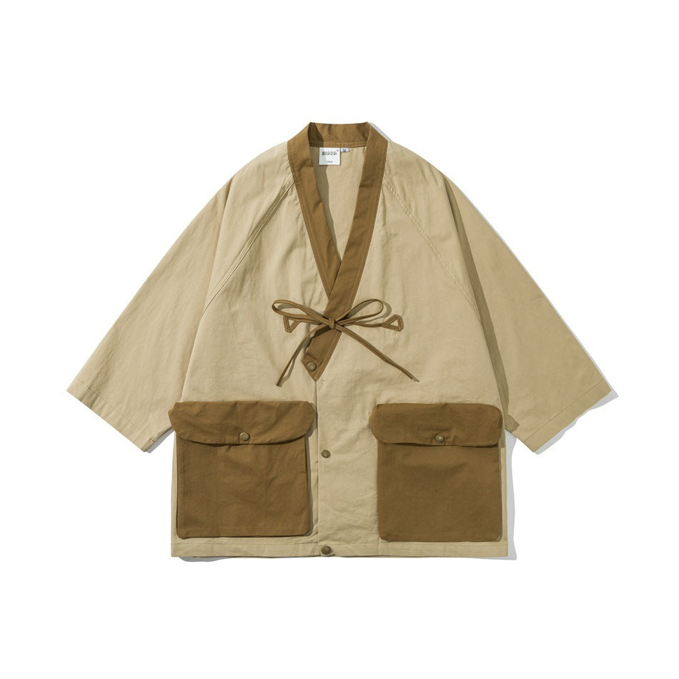 Khaki kimono-style jacket with brown contrast collar, tie closure and two large flap pockets, flat front view