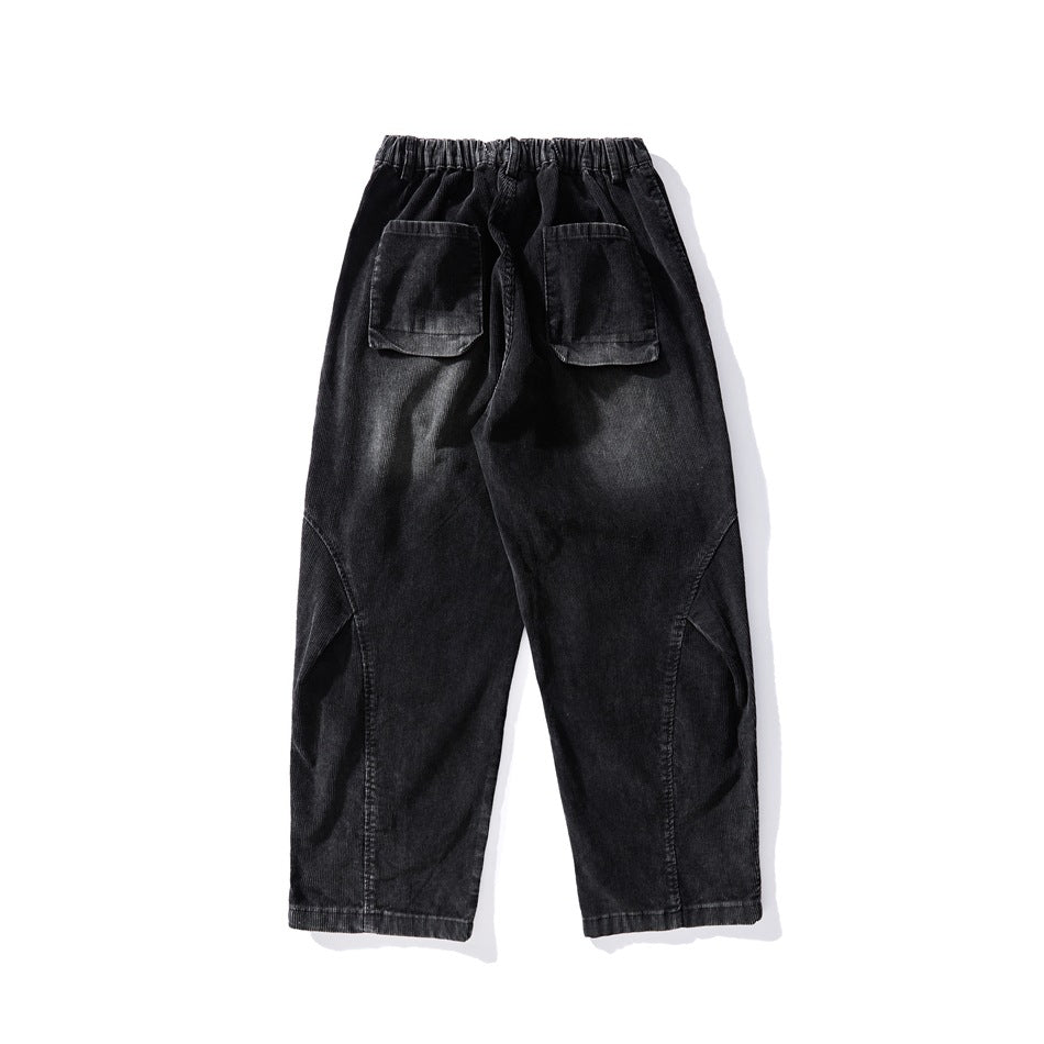 Black faded corduroy-style wide-leg pants, back flat lay with elastic waistband and two flap patch pockets