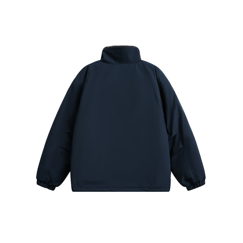 Back view of navy blue stand-collar jacket with plain back panel, sleeve seams and elasticated cuffs