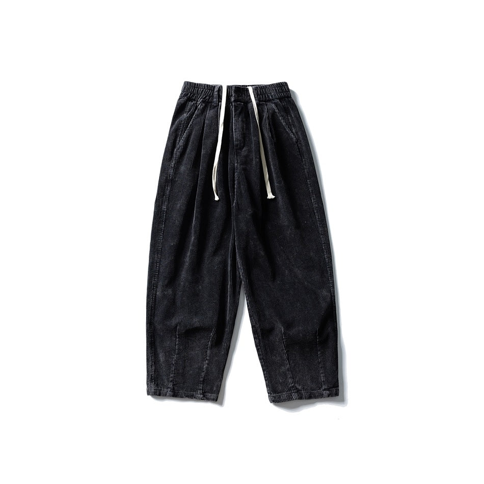 Washed black corduroy wide-leg pants with elastic waist and white drawstring, front flat lay