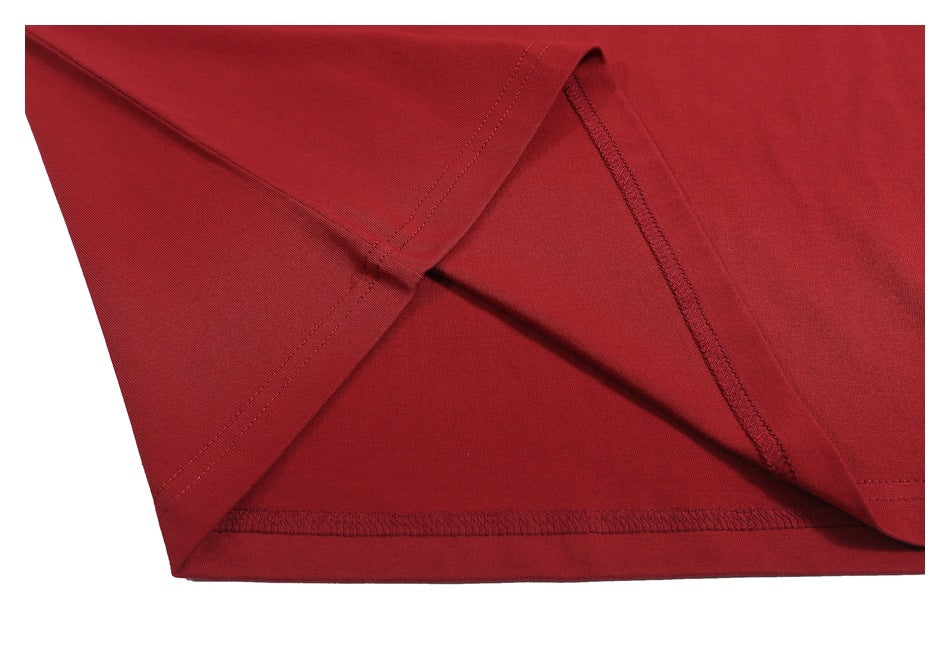 Close-up of the red T-shirt’s inside seams and stitching near the hem.
