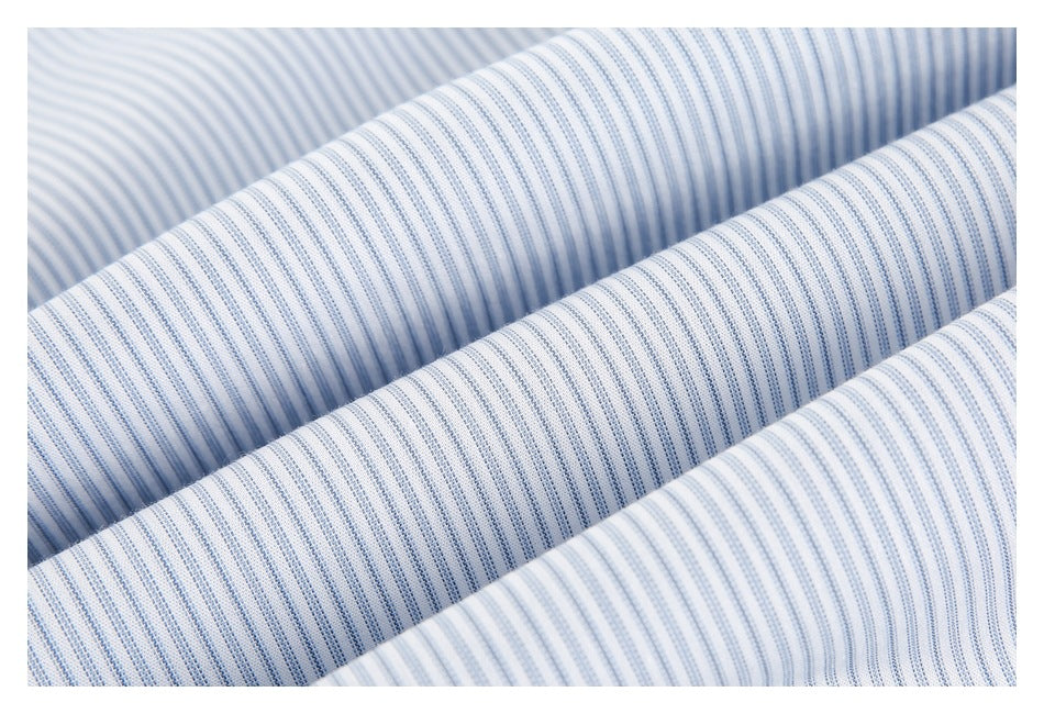 Close-up of softly folded white fabric with fine blue stripes.
