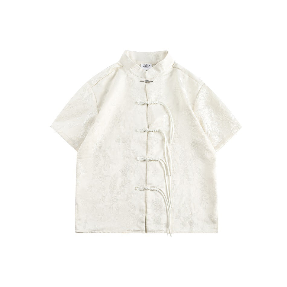 Off-white short-sleeve shirt with a stand collar, floral jacquard texture and knotted cord frog closures, flat front view