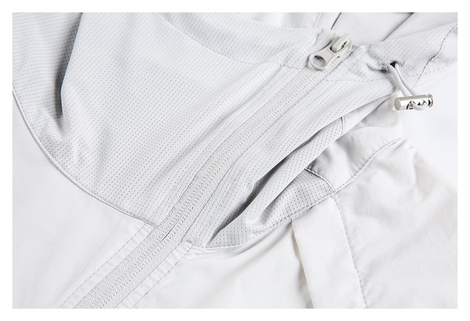 White jacket detail showing a mesh panel, front zipper, and adjustable drawcord toggle.