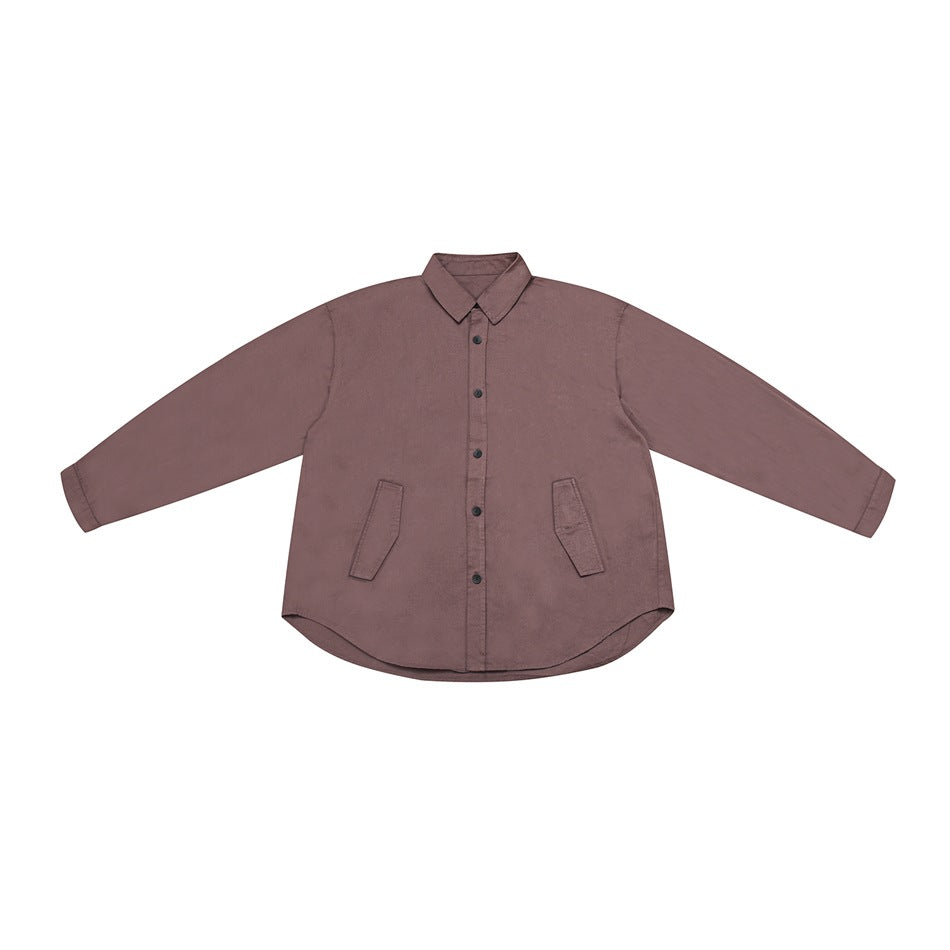 Brick red long-sleeve button-front shirt flat lay with collar, two flap pockets and curved hem