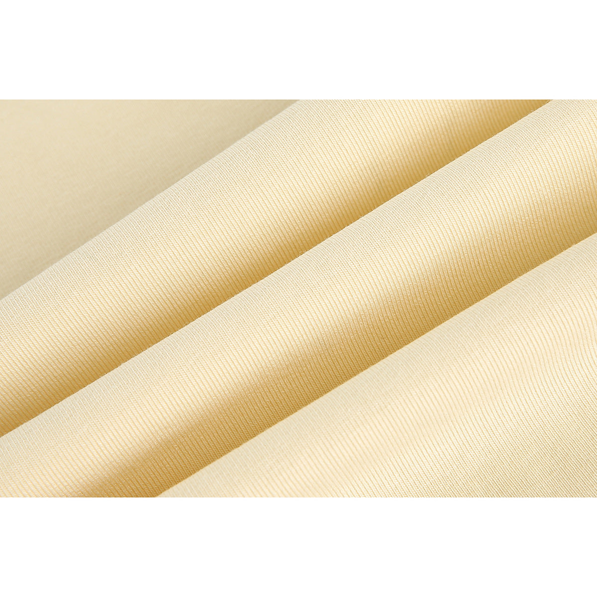 Close-up of pale yellow T-shirt fabric arranged in folds, showing its fine knit texture.