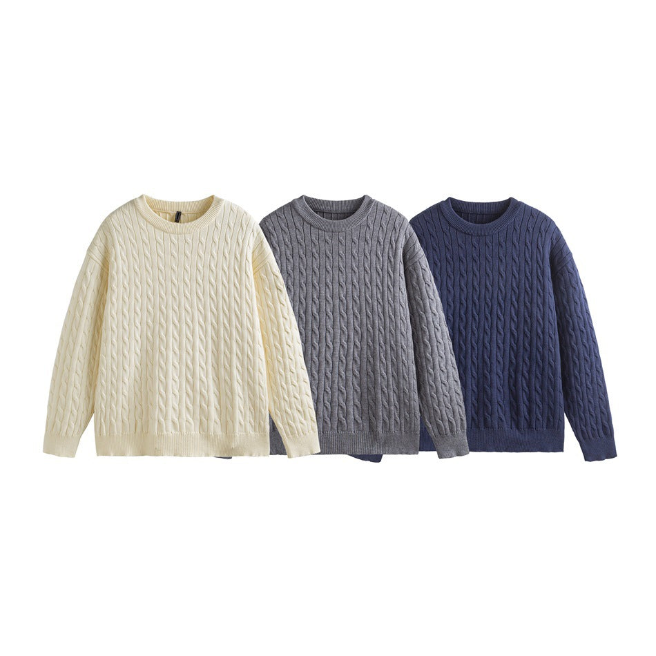 Three cable-knit crewneck sweaters shown flat in ivory, gray, and navy.