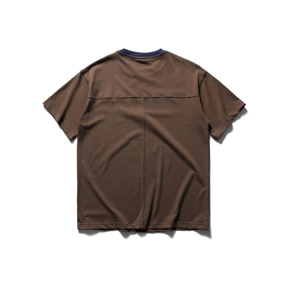 Full back view of a brown short-sleeve T-shirt with a navy collar, horizontal yoke seam, and vertical center seam.