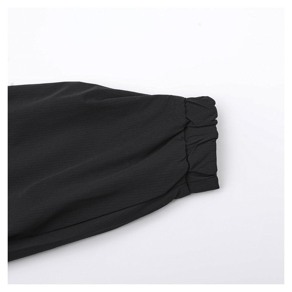 Close-up of a black sleeve ending in a gathered cuff.