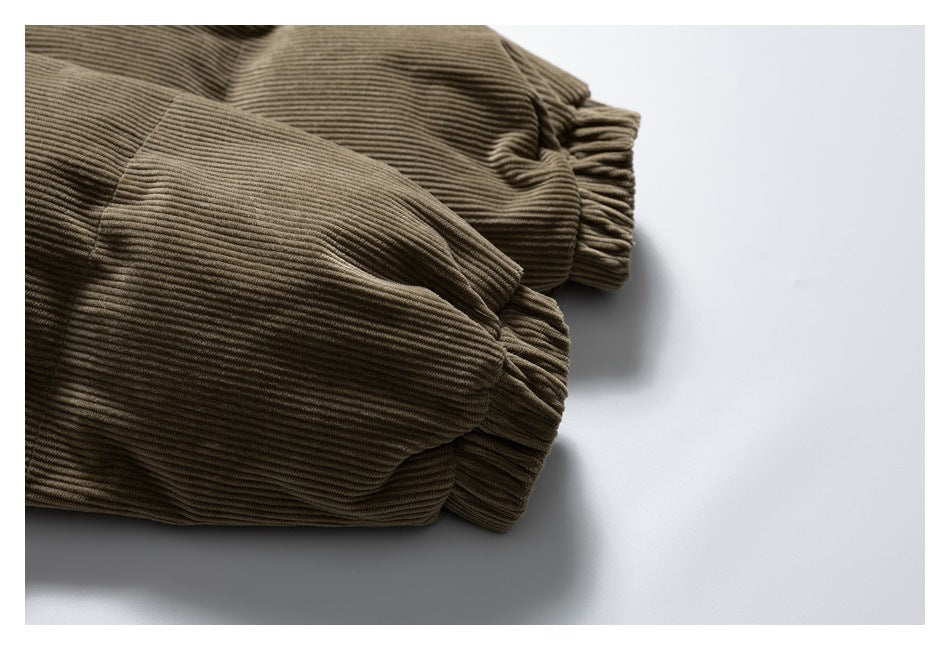 Close-up of brown corduroy jacket sleeves with gathered elastic cuffs.
