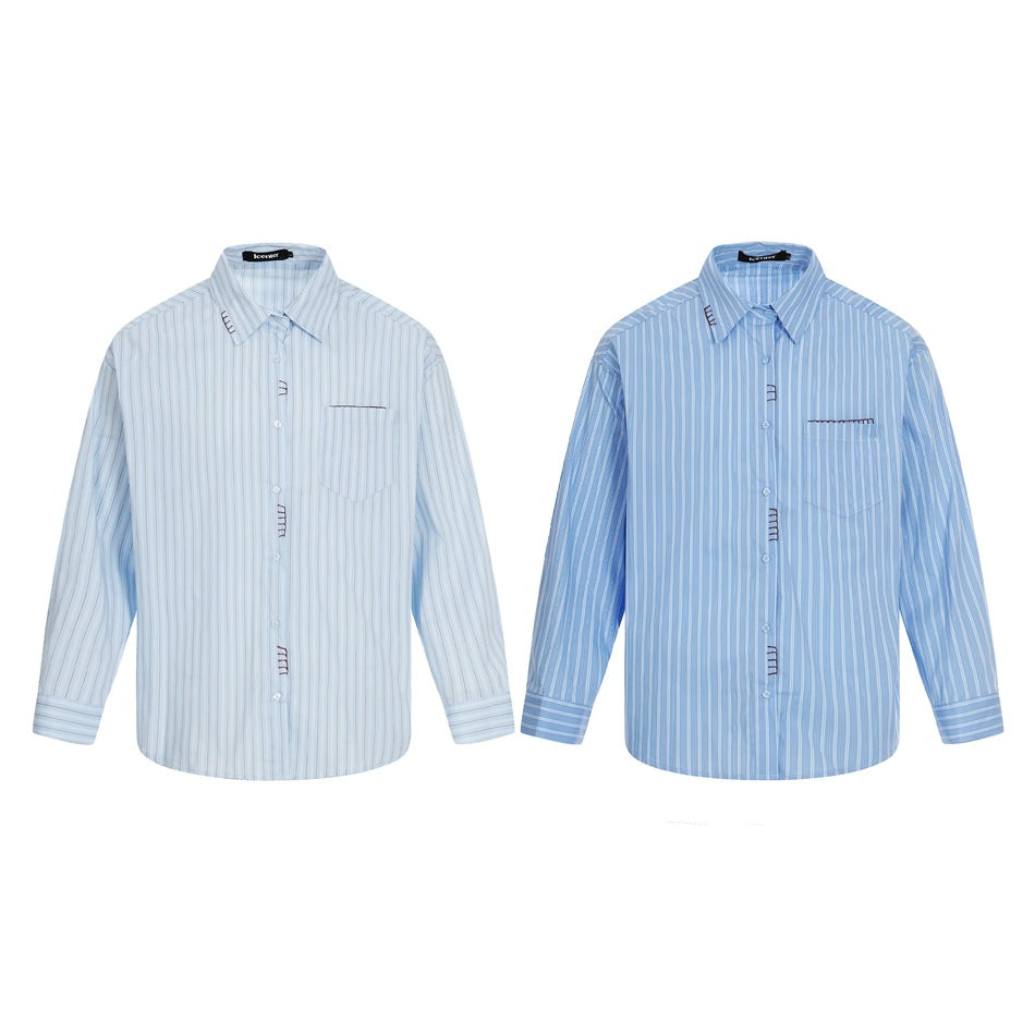 Two long-sleeved striped button-up shirts shown from the front in pale blue and medium blue.