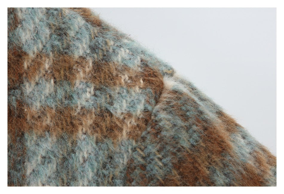 Close-up of the jacket's fuzzy blue-gray, cream, and brown checked fabric at the shoulder.