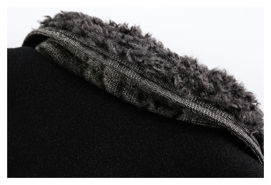 Close-up of a black garment edge with fuzzy dark trim and a gray patterned band.