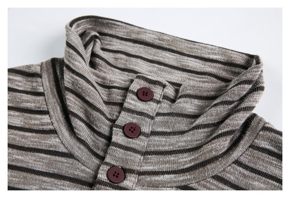 Close-up of a gray and black striped knit garment's collar and three-button placket.
