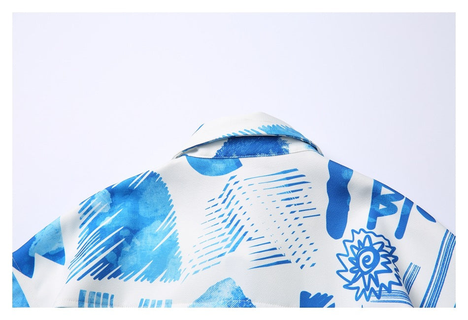 Close-up of the back collar and shoulders of a white shirt with blue abstract graphics.