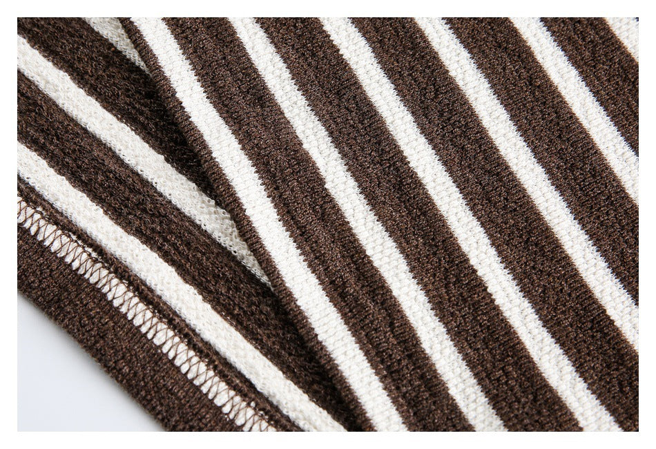 Close-up of the stitched edge and striped knit fabric of a brown-and-cream top.