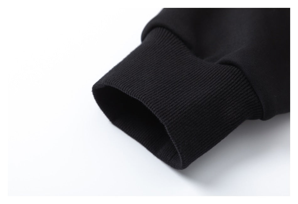 Close-up of a black sleeve ending in a wide ribbed cuff against a white background.