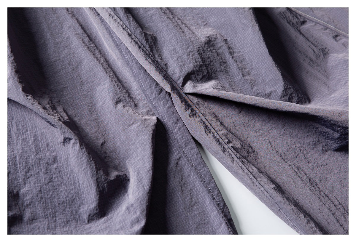 Close-up of gray shorts fabric and overlapping stitched seams.