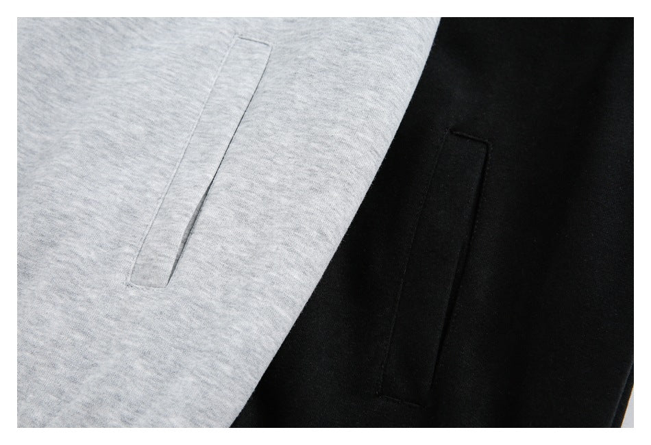Close-up of slanted pockets on light gray and black hooded sweatshirts.