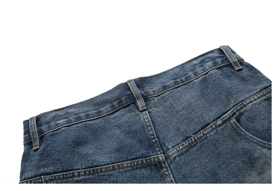 Close-up of the blue denim shorts waistband, belt loops, seams, and part of a front pocket.