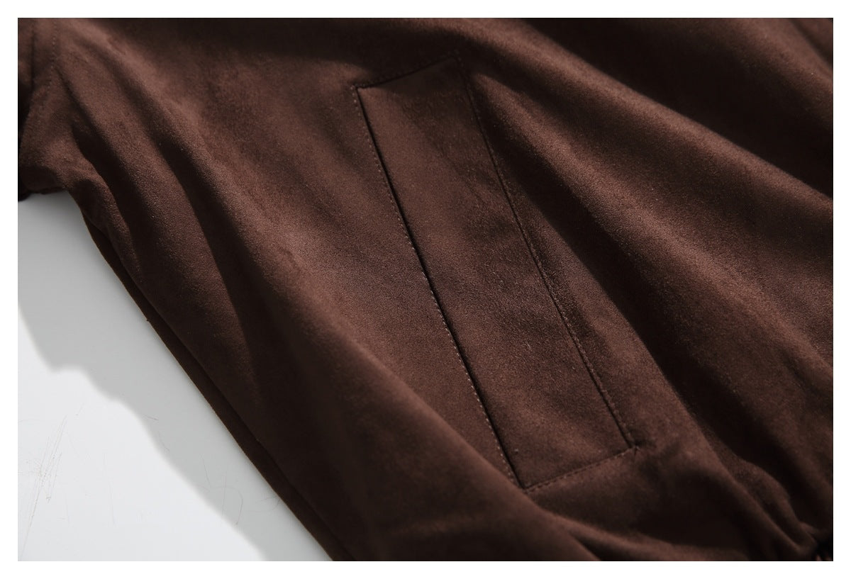 Close-up of a rectangular angled pocket on the dark brown jacket.