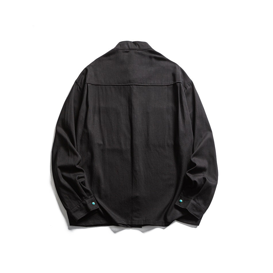 Back view of a black long-sleeve shirt with a stand collar and turquoise cuff buttons.