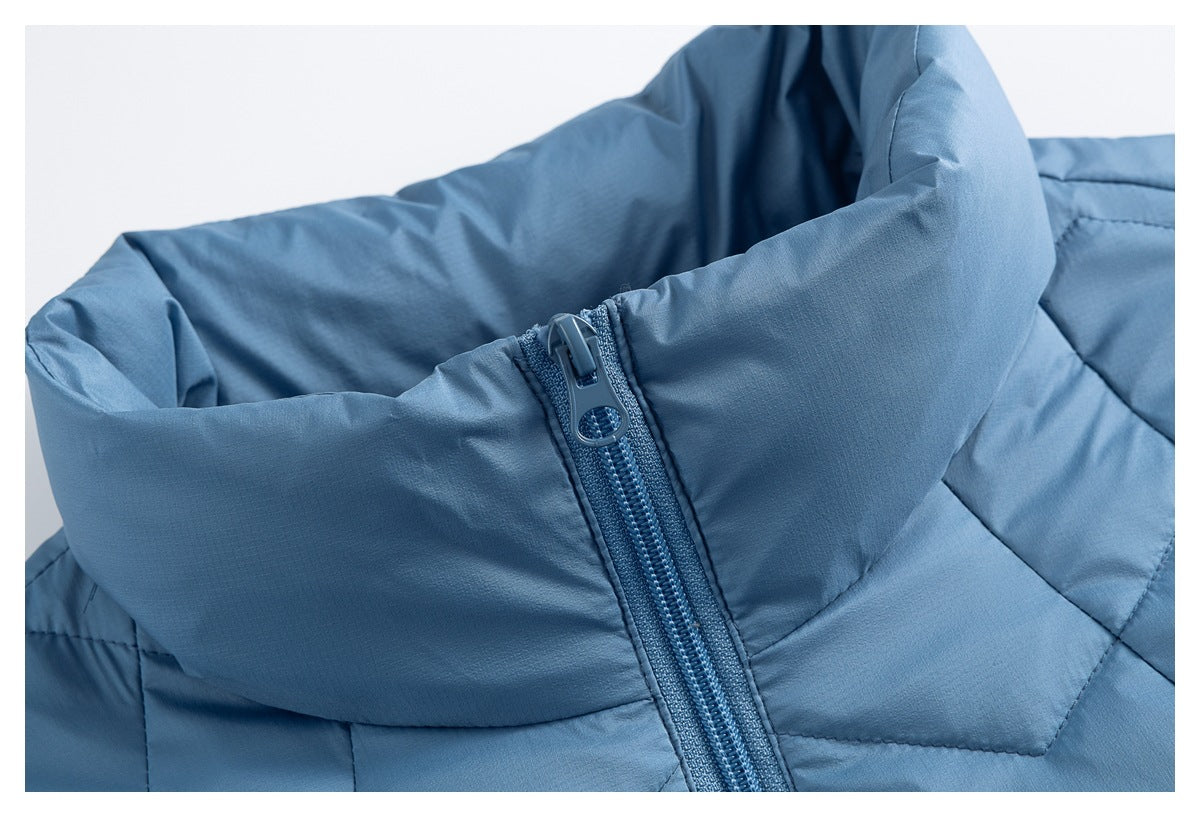 Close-up of the blue jacket's raised collar and zipper pull, showing the zipper teeth and angular quilting.