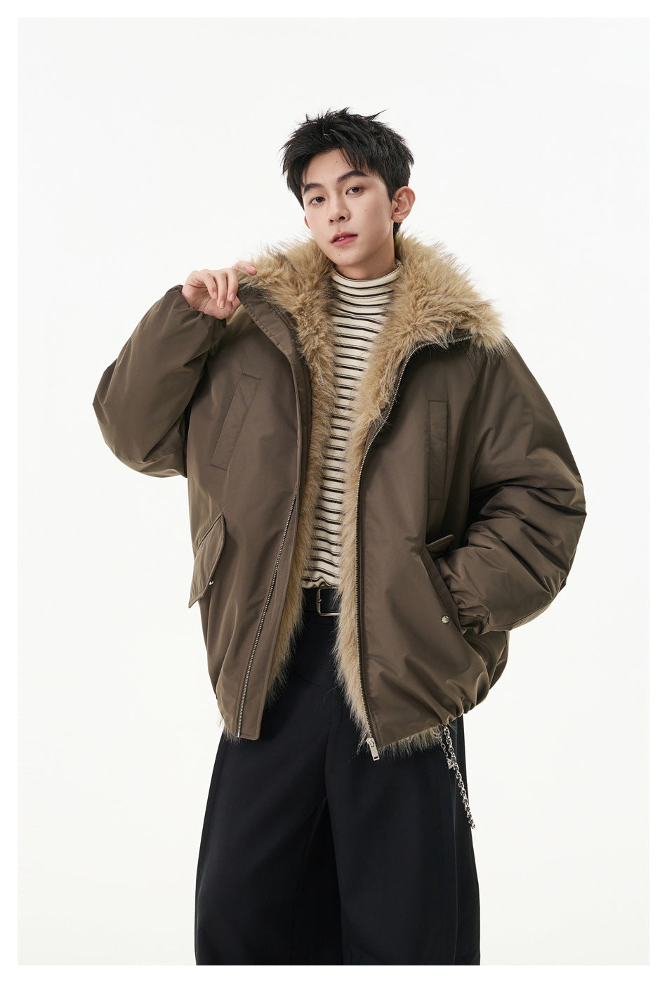Model wearing an open brown jacket with a large tan fur collar, zip closure, and flap pockets.