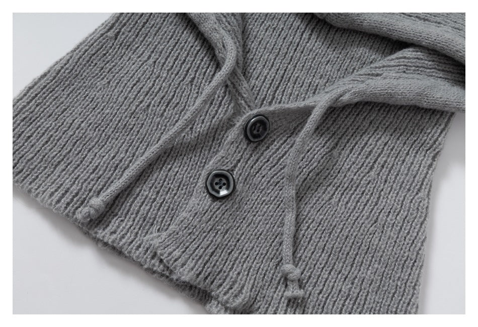 Close-up of the gray rib-knit neck warmer's two buttons, textured fabric, and drawstrings.