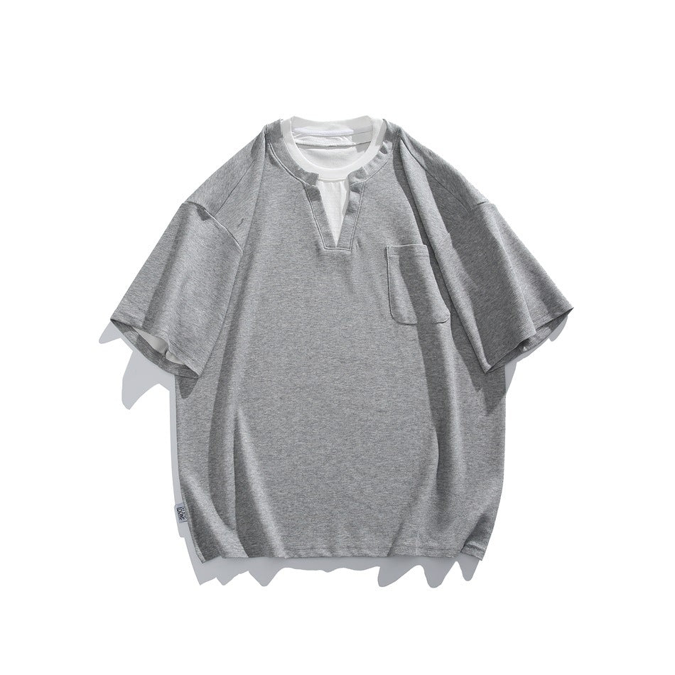 Gray short-sleeve T-shirt with notched V-neck, white inner collar layer and chest pocket, flat lay