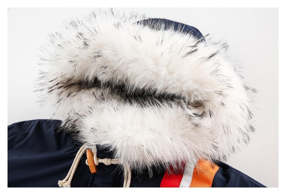 Close-up of the jacket's white fur-trimmed hood, cream drawcords, and red, white, and orange chest stripes.