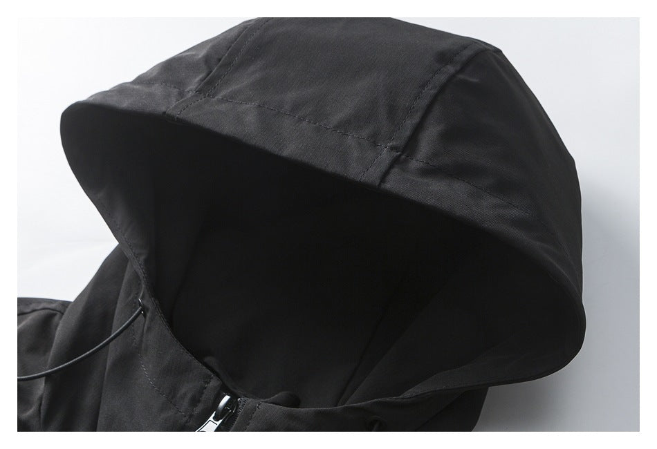 Close-up of a black jacket hood with stitched panels and a curved brim.