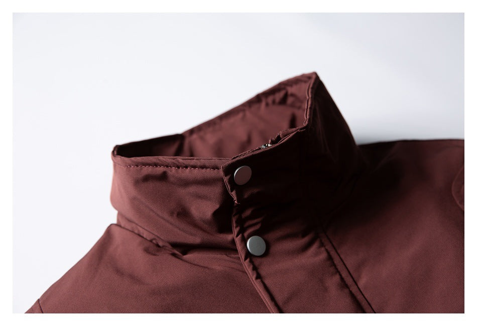 Close-up of the burgundy jacket's raised collar and two dark snap buttons.